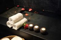 a black table with towels and candles on it at Yunoyado Onsen Hot Spring Hotel -Xinyi Branch in Jiaoxi