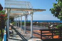 a white pergola with benches and the beach at Blue Ocean Sunny BS in Checheng