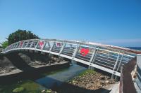 a bridge over a river with people on it at Blue Ocean Sunny BS in Checheng