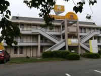 a building with a staircase in front of it at Premiere Classe Cambrai Proville in Cambrai