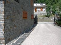 a brick alley way with a building and a wall at Appartement les rives de l’Ariège in Luzenac
