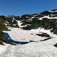 a snow covered mountain with a river in it at Ancienne école du Mont in Servoz