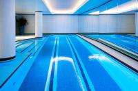 a swimming pool with blue water in a building at Hotel Eiffel Blomet in Paris
