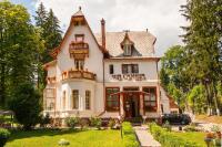 a large white house with a sign that reads wine cottage at Vila Camelia in Sinaia