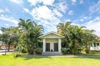 a house with palm trees in front of it at Ville Greensward in Taitung City