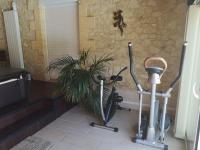 a room with two exercise bikes and a plant at Le Mas des Geais in Atur