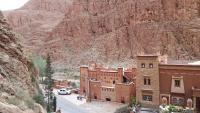 a building in the middle of a mountain at Riad Atlas Berbère in Boumalne