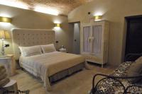 Łóżko lub łóżka w pokoju w obiekcie Corte degli Angeli Agriturismo