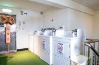 a laundry room with two washes and a star on the wall at Hualien Wow Hostel in Hualien City
