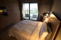 a bedroom with a large bed and a window at The Light in Hengchun South Gate