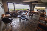 a restaurant with tables and chairs and a large window at The Light in Hengchun South Gate