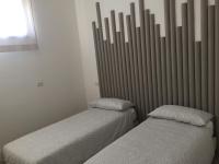 A bed or beds in a room at Rosy House - Hospitality