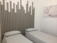 A bed or beds in a room at Rosy House - Hospitality