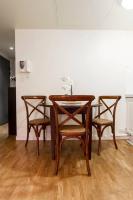 a dining room table with four chairs around it at Champs Elysees Flat in Paris