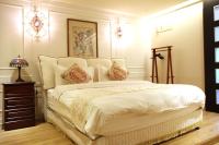 a bedroom with a large white bed with pillows at Ritual and Breakfast in Hualien City