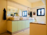 a bathroom with two sinks and two mirrors at Trip GG Hostel in Kaohsiung