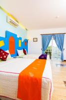 a bedroom with two beds with blue and orange at Ocean Star B&amp;B in Kenting