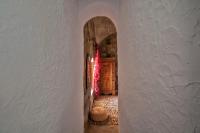 a hallway with a white wall and a door at Hostal El Asturiano in Tarifa