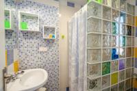 a bathroom with a sink and a shower with a glass wall at Hostal El Asturiano in Tarifa