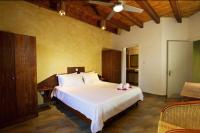 a bedroom with a large white bed in a room at Villa Sole in Anse Volbert Village