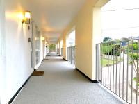 an empty hallway of a building with a balcony at Westward 14 Polzeath in Polzeath