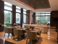 a restaurant with tables and chairs and a bar at LJZ Supreme Tower Hotel in Shanghai