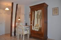 a room with a mirror and a table and chairs at LA MAISON DU PECHEUR in Chaumont-sur-Loire