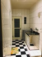 a kitchen with a black and white checkered floor at 橙橙民宿 in Ruifang