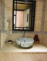 a sink in a bathroom with a large mirror at 橙橙民宿 in Ruifang