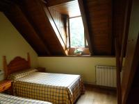 a bedroom with two beds and a window at Casa Es Neres in Les