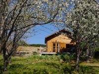 a small wooden house in a field with trees at Le Chalet in Prémian
