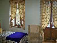 a bedroom with a bed and a chair and a window at Casa Es Neres in Les