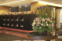 a vase of flowers on a table in a lobby at King&#39;s Town Hotel in Kaohsiung