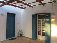 a house with two blue doors and a window at Villa in the Garden in Kokkini Khanion