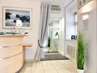 a hallway with an open door with plants at Boulogne Résidence Hotel in Boulogne-Billancourt