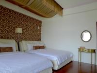 a bedroom with two beds and a mirror on the wall at Amicasa Guesthouse in Hualien City