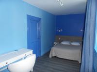a blue bedroom with a bed and a white sink at Chambres d&#39;hôtes d&#39;Accolay in Accolay