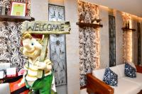 a statue of a person holding a welcome sign in a room at Kenting Garden Homestay in Kenting