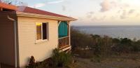 a small house with a view of the ocean at bel ti kay in Les Anses-dʼArlets