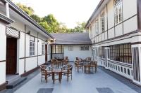 a courtyard with tables and chairs in a building at Hickory Penang Hill in George Town