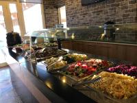 a buffet line with many different types of food at Hotel Kamomil in Durrës