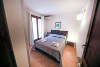 A bed or beds in a room at Kelly Apartments Cefalù
