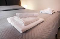A bed or beds in a room at Kelly Apartments Cefalù