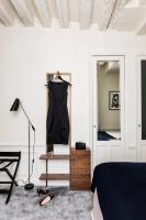 a bedroom with a dresser and a mirror and a bed at Hotel Verneuil Saint Germain in Paris