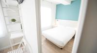 Postel nebo postele na pokoji v ubytování Happy Hostal Carrales