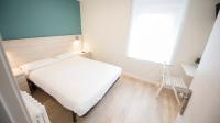 Postel nebo postele na pokoji v ubytování Happy Hostal Carrales