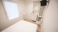 Postel nebo postele na pokoji v ubytování Happy Hostal Carrales
