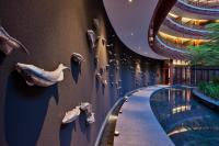 a swimming pool with fish on the wall at Capella Singapore in Singapore