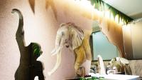 a statue of an elephant on the wall of a bathroom at Yang Ming Shan Tien Lai Resort &amp; Spa in Jinshan