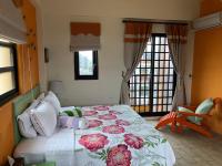 a bedroom with a large bed with flowers on it at Remember Sea View B&amp;B in Huxi